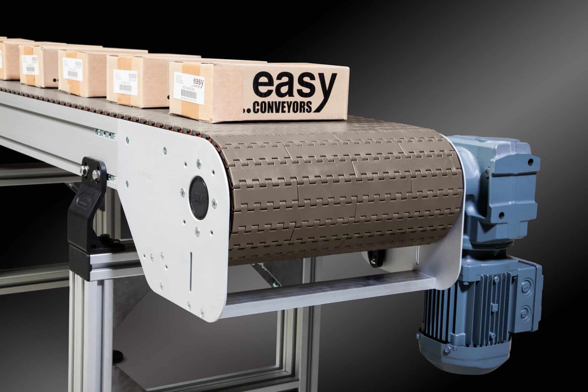 EMCS chain conveyors in action, transporting a large cardboard box.